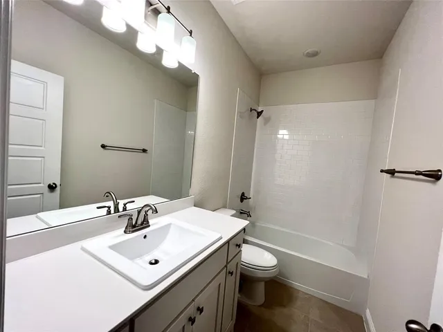 a bathroom with a sink toilet a mirror and shower