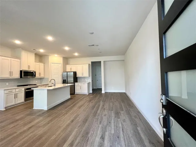 a kitchen with a sink and a refrigerator