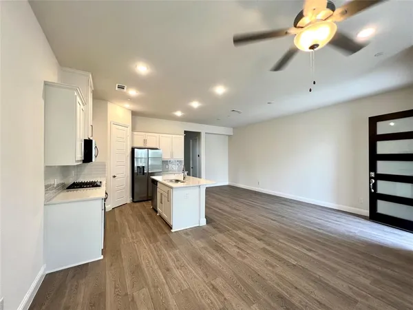 a view of kitchen with sink microwave and stove