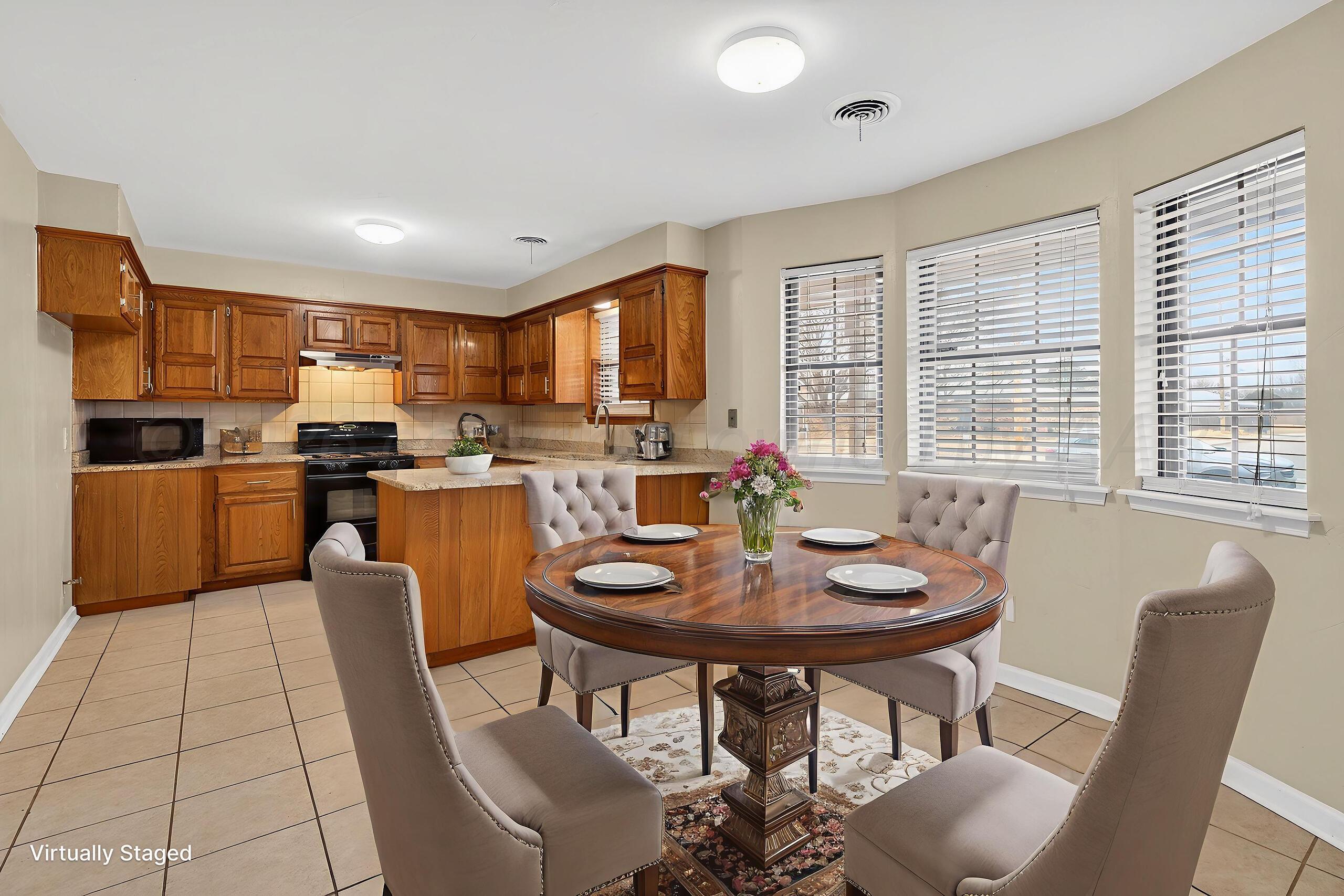 7313 Holyoke Trail Amarillo, TX 79121 - Photo 14 of 56 a kitchen with a dining table chairs and refrigerator