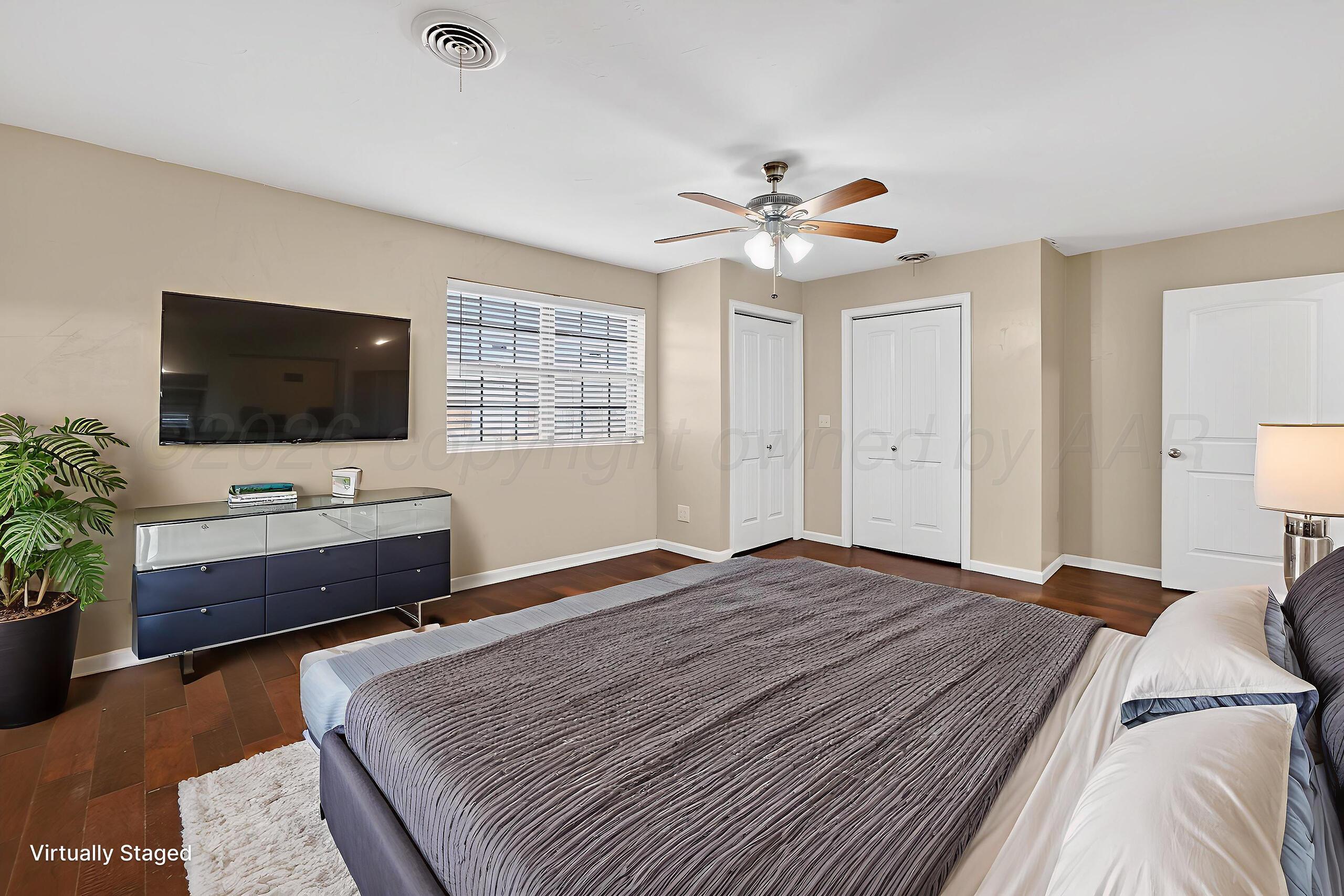 7313 Holyoke Trail Amarillo, TX 79121 - Photo 27 of 56 a bedroom with a bed and a flat screen tv