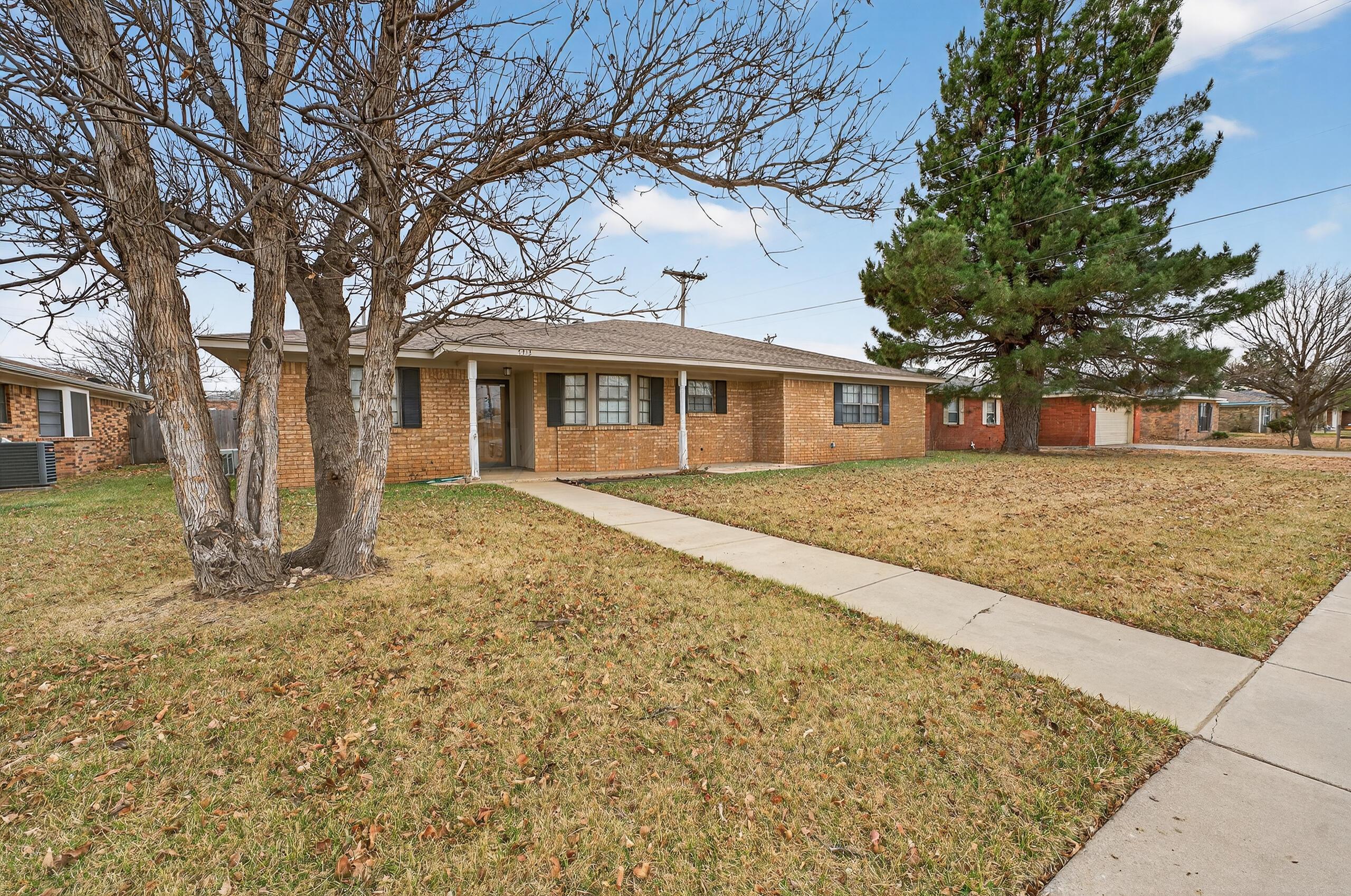 7313 Holyoke Trail Amarillo, TX 79121 - Photo 3 of 56 front view of a house with a yard