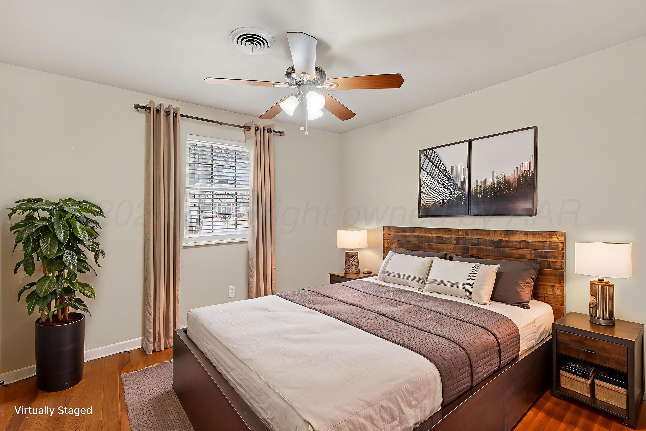 7313 Holyoke Trail Amarillo, TX 79121 - Photo 38 of 56 a bedroom with a bed and a potted plant