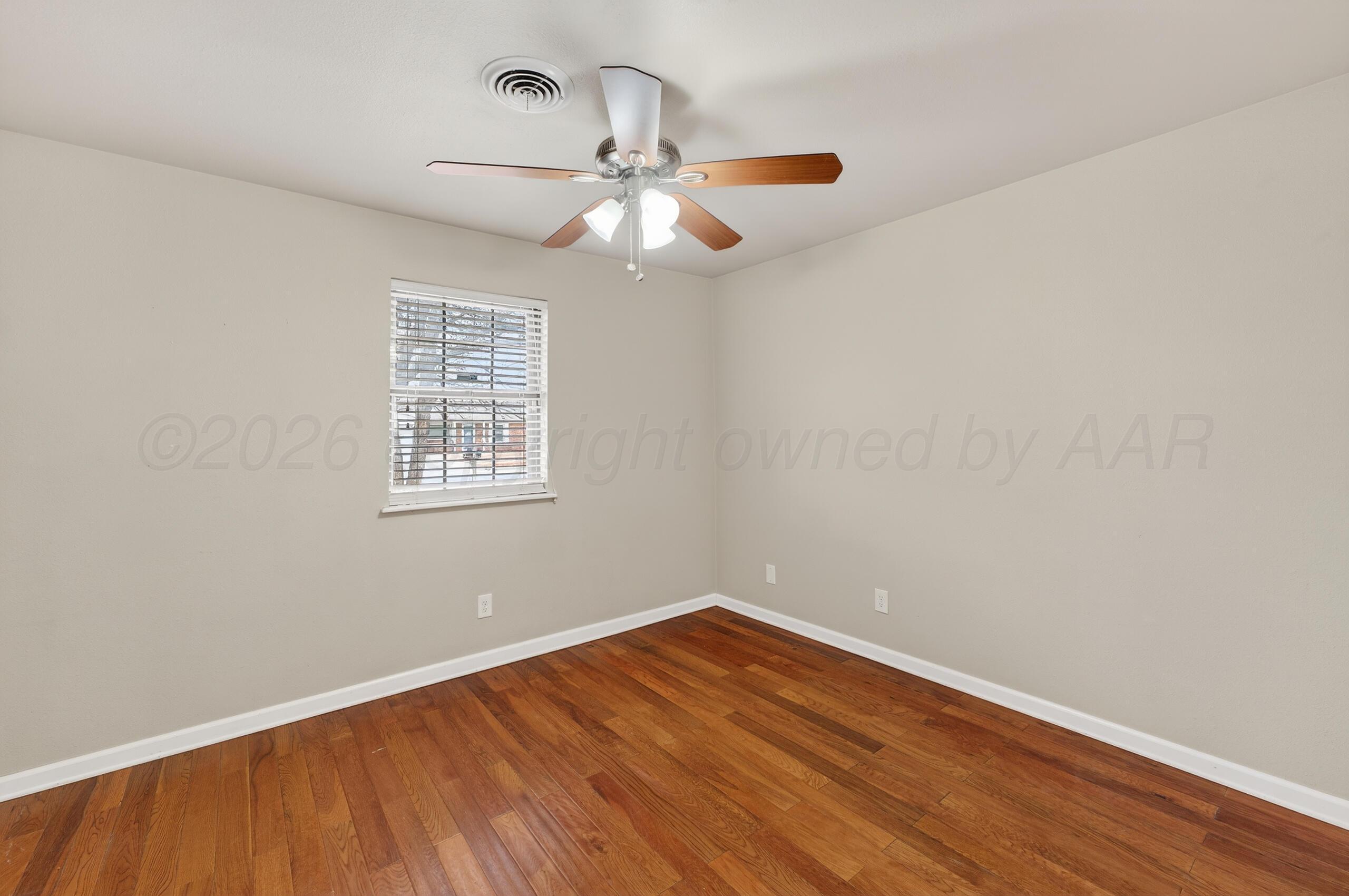 7313 Holyoke Trail Amarillo, TX 79121 - Photo 39 of 56 wooden floor in an empty room with a window