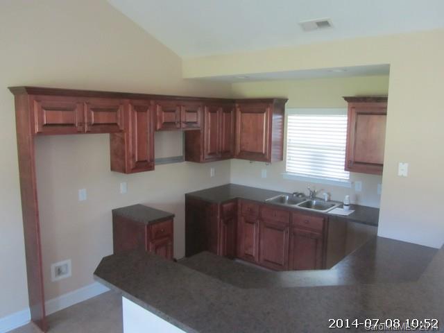 2904 Ruben Road, Unit 3 Monroe, NC 28112 - Photo 4 of 9 a kitchen with stainless steel appliances granite countertop a sink and a refrigerator