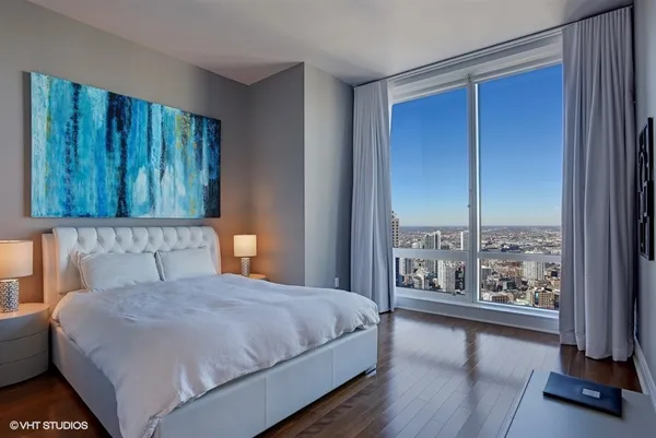a bedroom with a large bed and a window