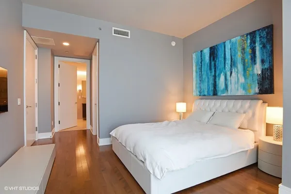 a bedroom with a bed and a night stand