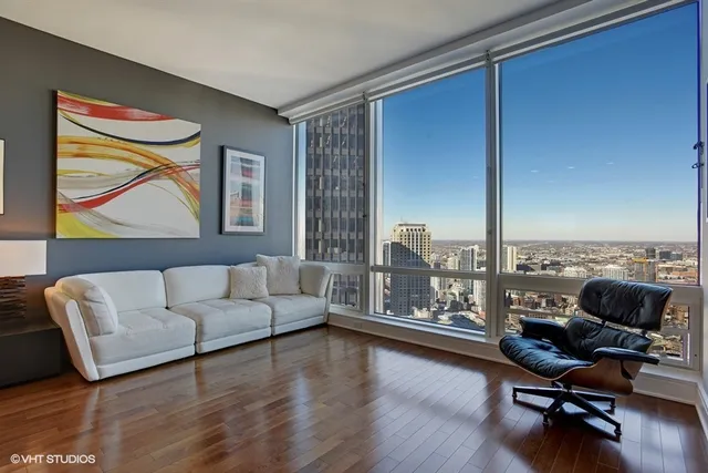 a living room with furniture and floor to ceiling window