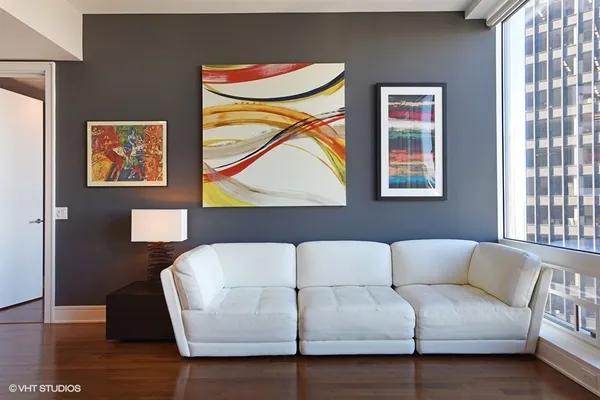 a living room with a couch and a painting on the wall