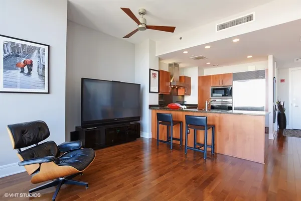 a living room with furniture and kitchen view