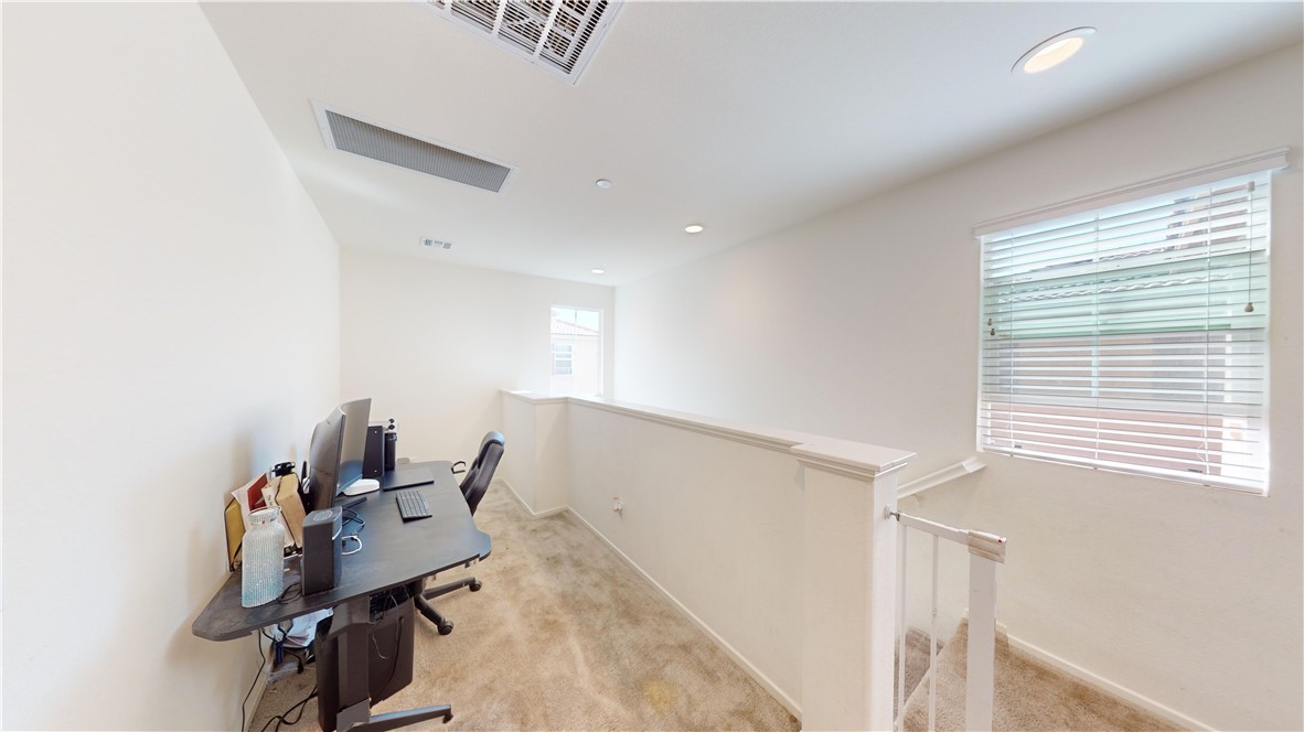 165 Linden Court Perris, CA 92571 - Photo 12 of 36 a view of a workspace with furniture and a window