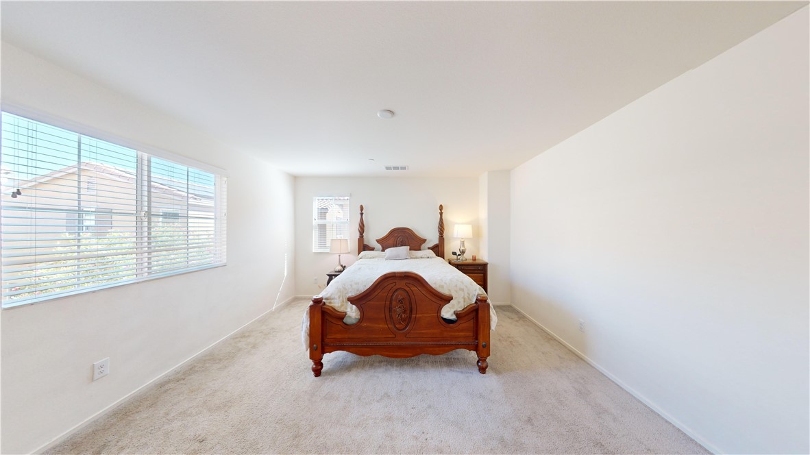 165 Linden Court Perris, CA 92571 - Photo 13 of 36 a room with a bed and a window