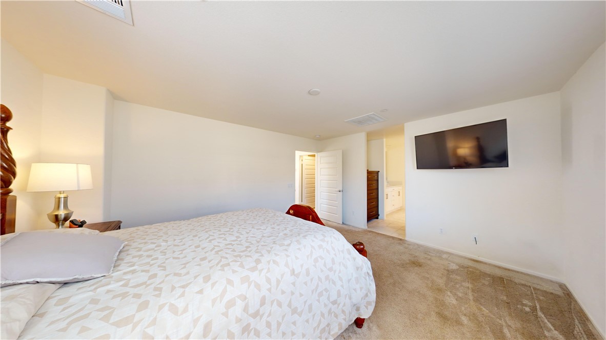 165 Linden Court Perris, CA 92571 - Photo 14 of 36 a bedroom with a bed and a flat screen tv