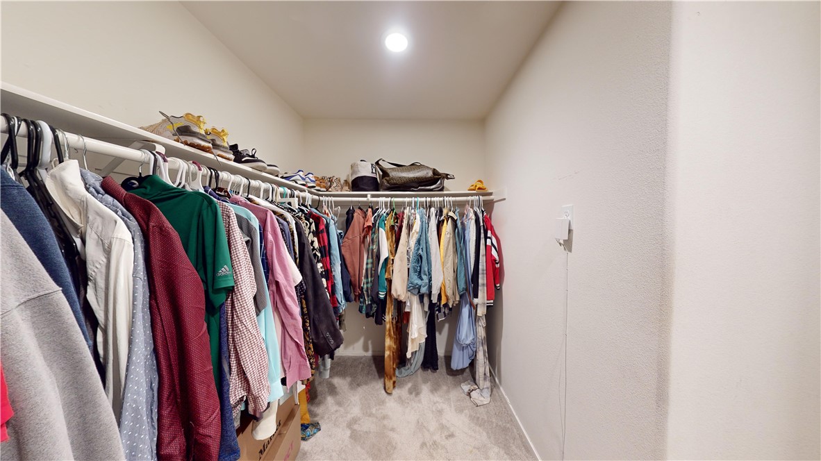165 Linden Court Perris, CA 92571 - Photo 15 of 36 a view of walk in closet with clothes