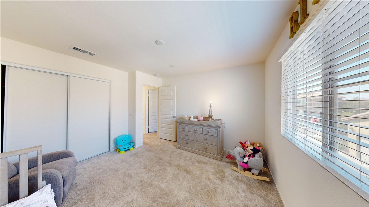 165 Linden Court Perris, CA 92571 - Photo 22 of 36 a bed room with a bed and a window