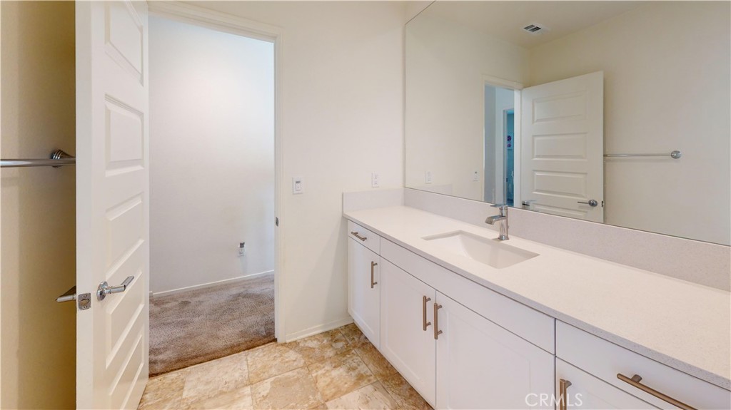 165 Linden Court Perris, CA 92571 - Photo 23 of 36 a bathroom with a double vanity sink and a mirror