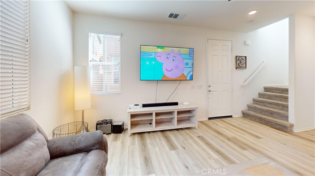 165 Linden Court Perris, CA 92571 - Photo 10 of 36 a living room with furniture and a flat screen tv
