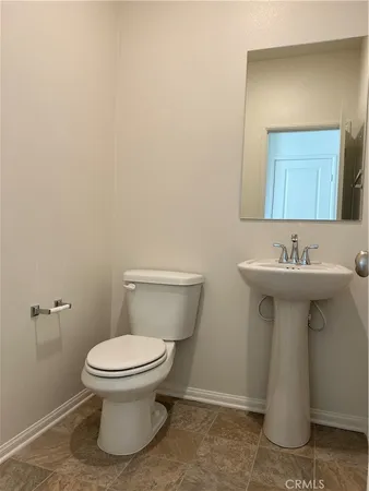 a bathroom with a sink toilet and a mirror