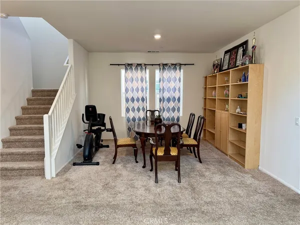 a view of a livingroom with furniture and staircase