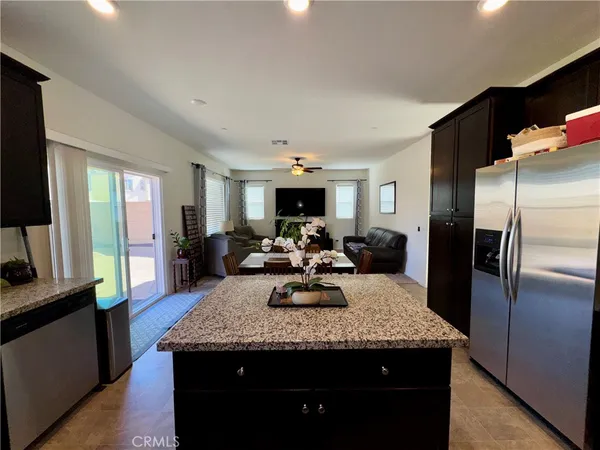 a view of a kitchen counter top space with furniture wooden floor a chandelier