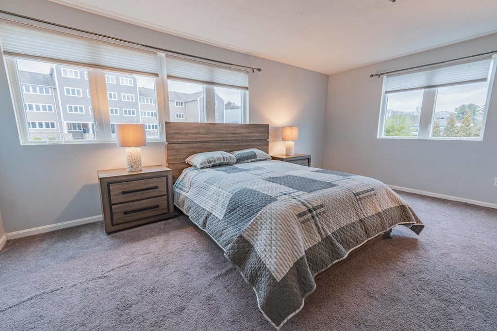 38 Dunham Road, Unit 210 Beverly, MA 01915 - Photo 15 of 30 a bedroom with a bed and a window