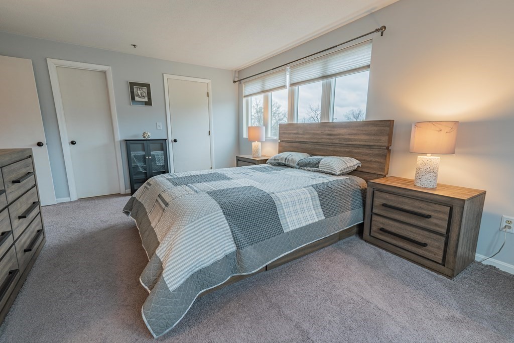 38 Dunham Road, Unit 210 Beverly, MA 01915 - Photo 17 of 30 a bedroom with a bed and a window