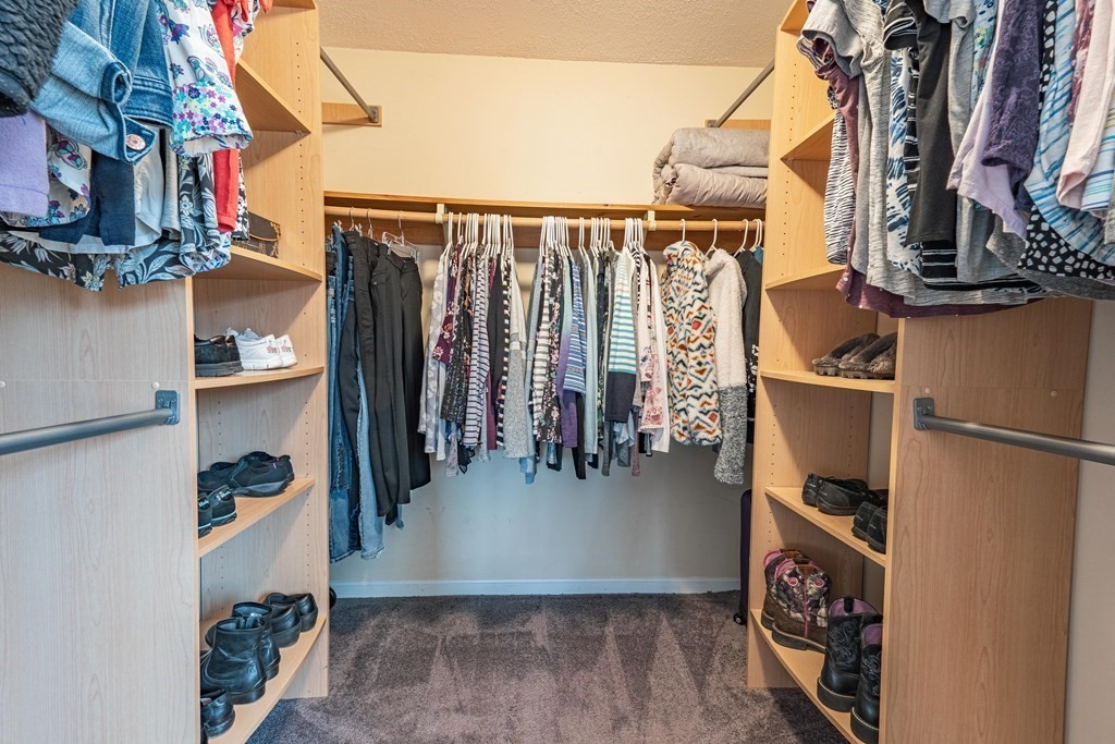 38 Dunham Road, Unit 210 Beverly, MA 01915 - Photo 18 of 30 a view of walk in closet with clothes and shoes