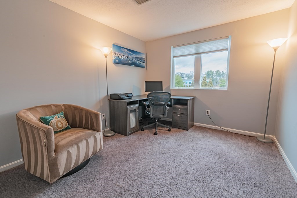 38 Dunham Road, Unit 210 Beverly, MA 01915 - Photo 20 of 30 a living room with furniture and a window