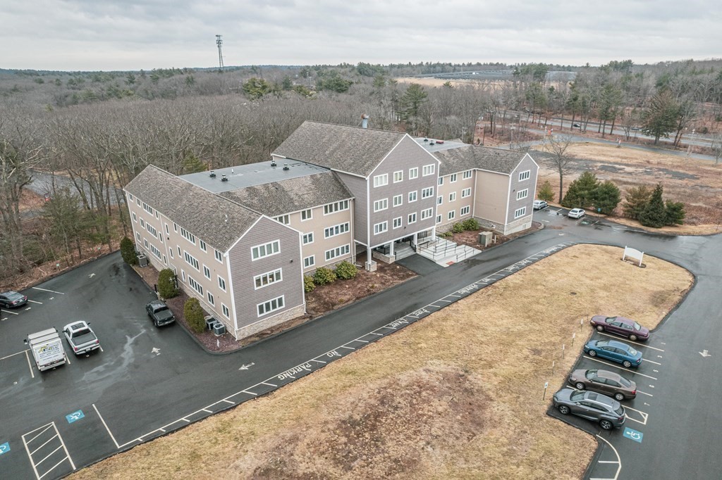 38 Dunham Road, Unit 210 Beverly, MA 01915 - Photo 23 of 30 a view of a terrace with a yard