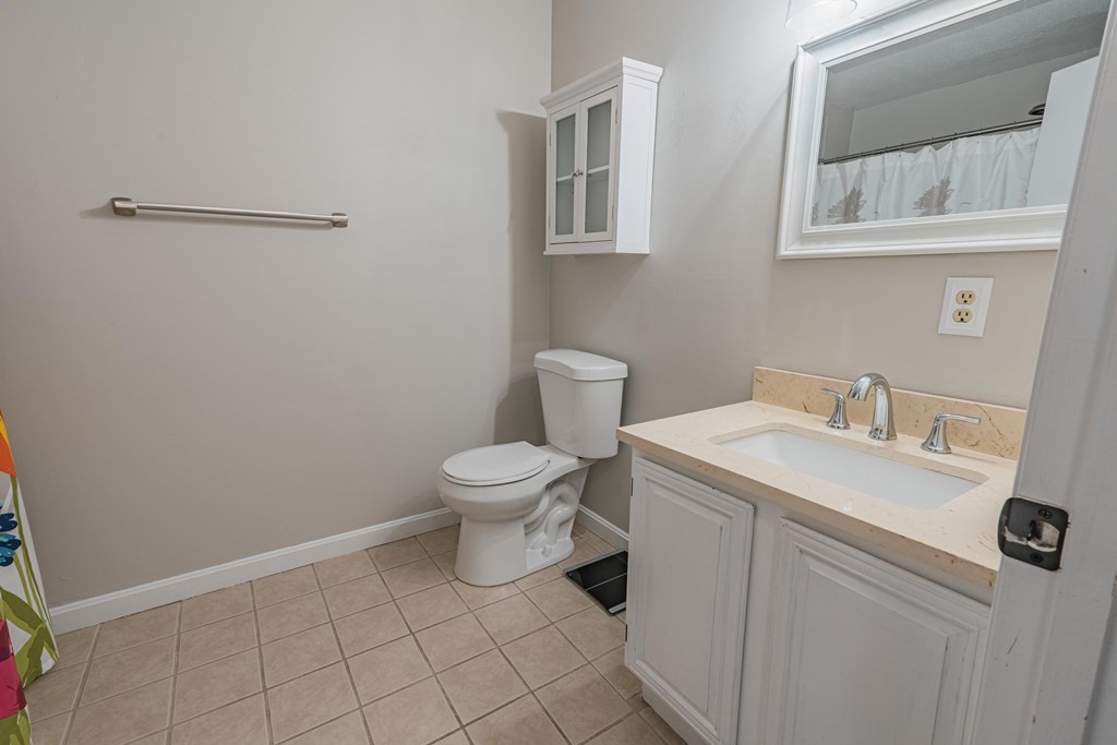 38 Dunham Road, Unit 210 Beverly, MA 01915 - Photo 26 of 30 a white toilet sitting next to a bathroom sink