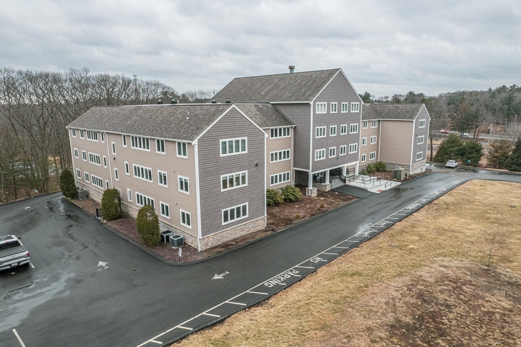 38 Dunham Road, Unit 210 Beverly, MA 01915 - Photo 3 of 30 aerial view of a house with a yard