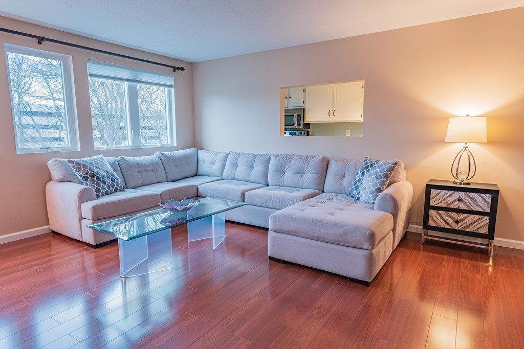 38 Dunham Road, Unit 210 Beverly, MA 01915 - Photo 7 of 30 a living room with furniture and a window