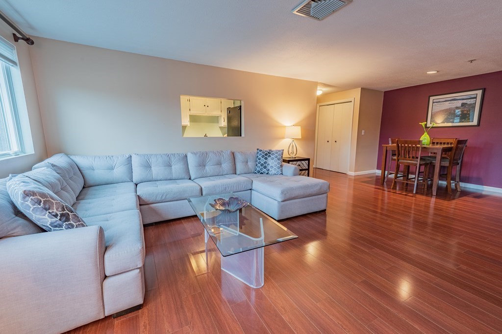 38 Dunham Road, Unit 210 Beverly, MA 01915 - Photo 8 of 30 a living room with furniture and wooden floor