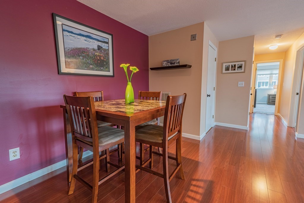 38 Dunham Road, Unit 210 Beverly, MA 01915 - Photo 9 of 30 a view of a dining room with furniture and wooden floor