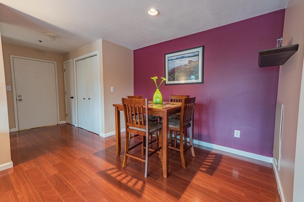 38 Dunham Road, Unit 210 Beverly, MA 01915 - Photo 10 of 30 a view of a dining room with furniture and wooden floor