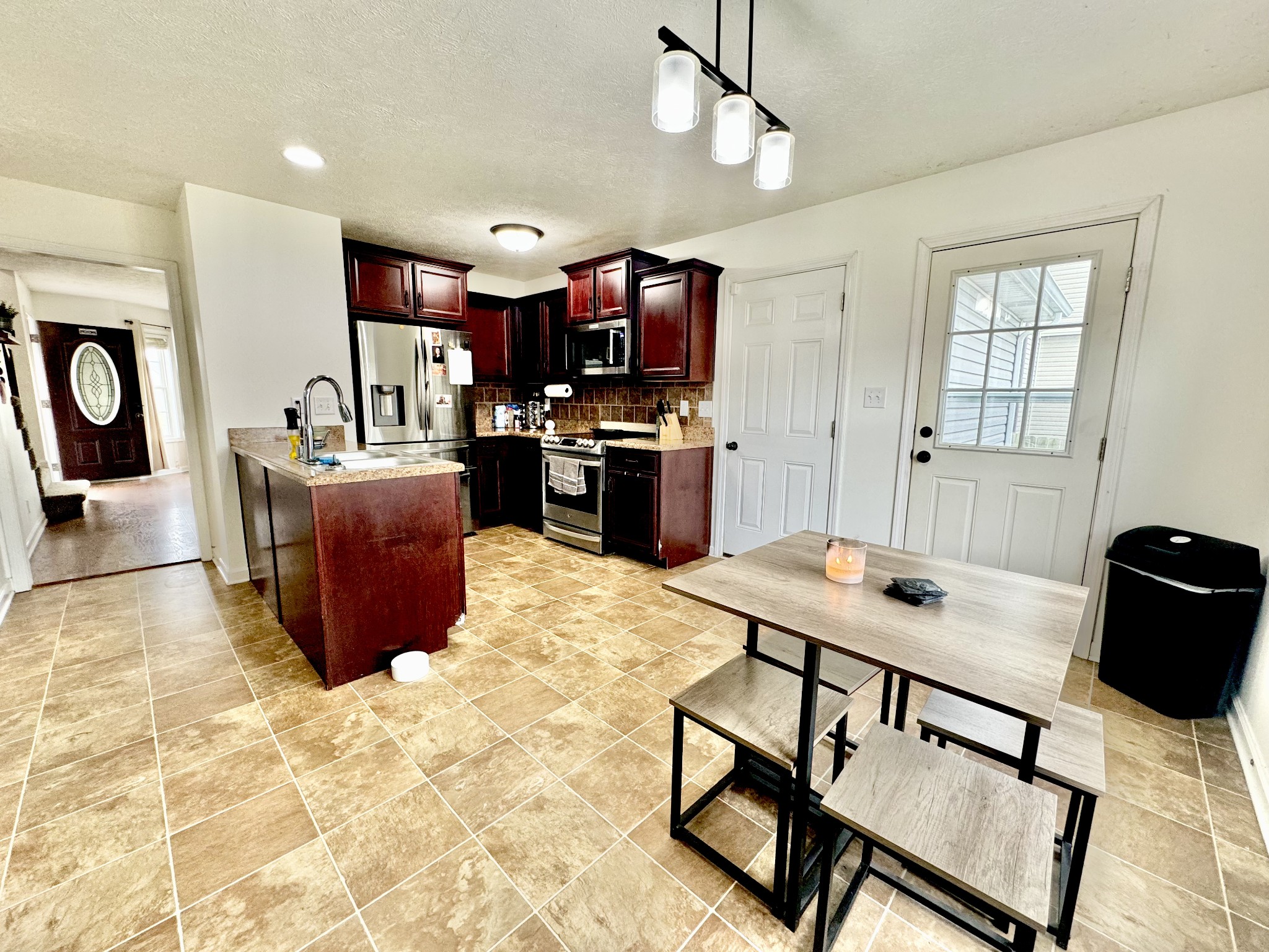 3769 Suiter Road Clarksville, TN 37040 - Photo 3 of 10 a living room with furniture a flat screen tv and kitchen view
