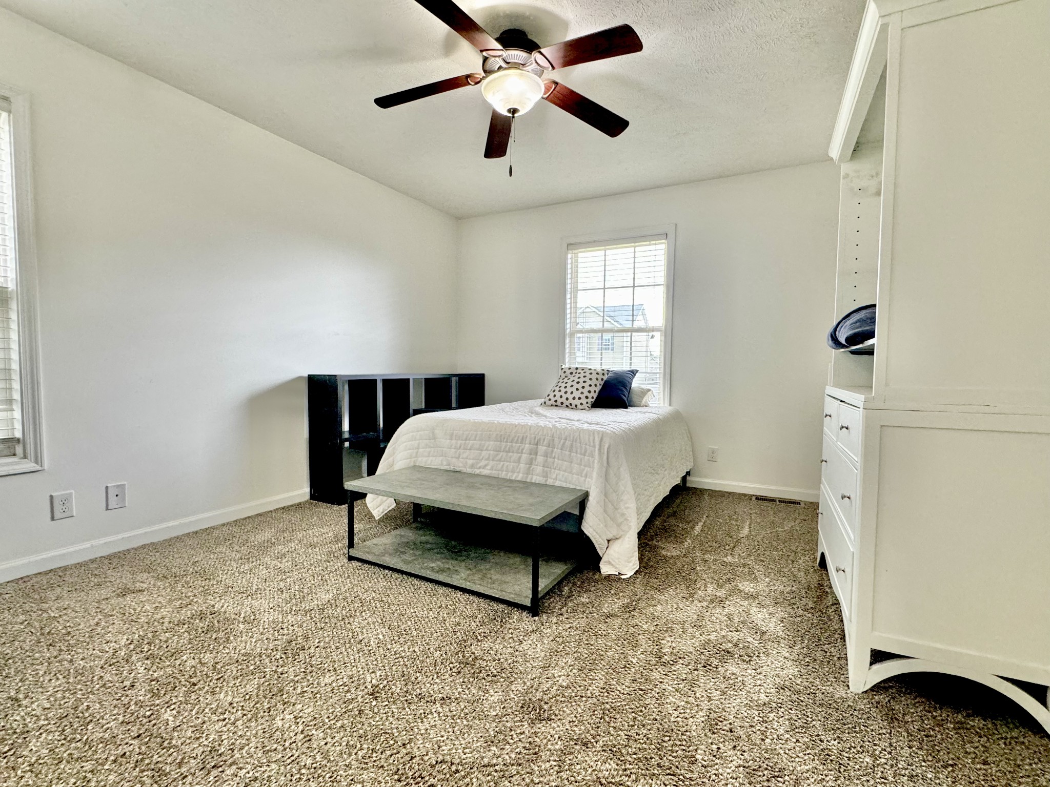3769 Suiter Road Clarksville, TN 37040 - Photo 6 of 10 a spacious bedroom with a bed and a chandelier