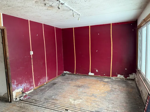 a view of a room with wooden floor and chair