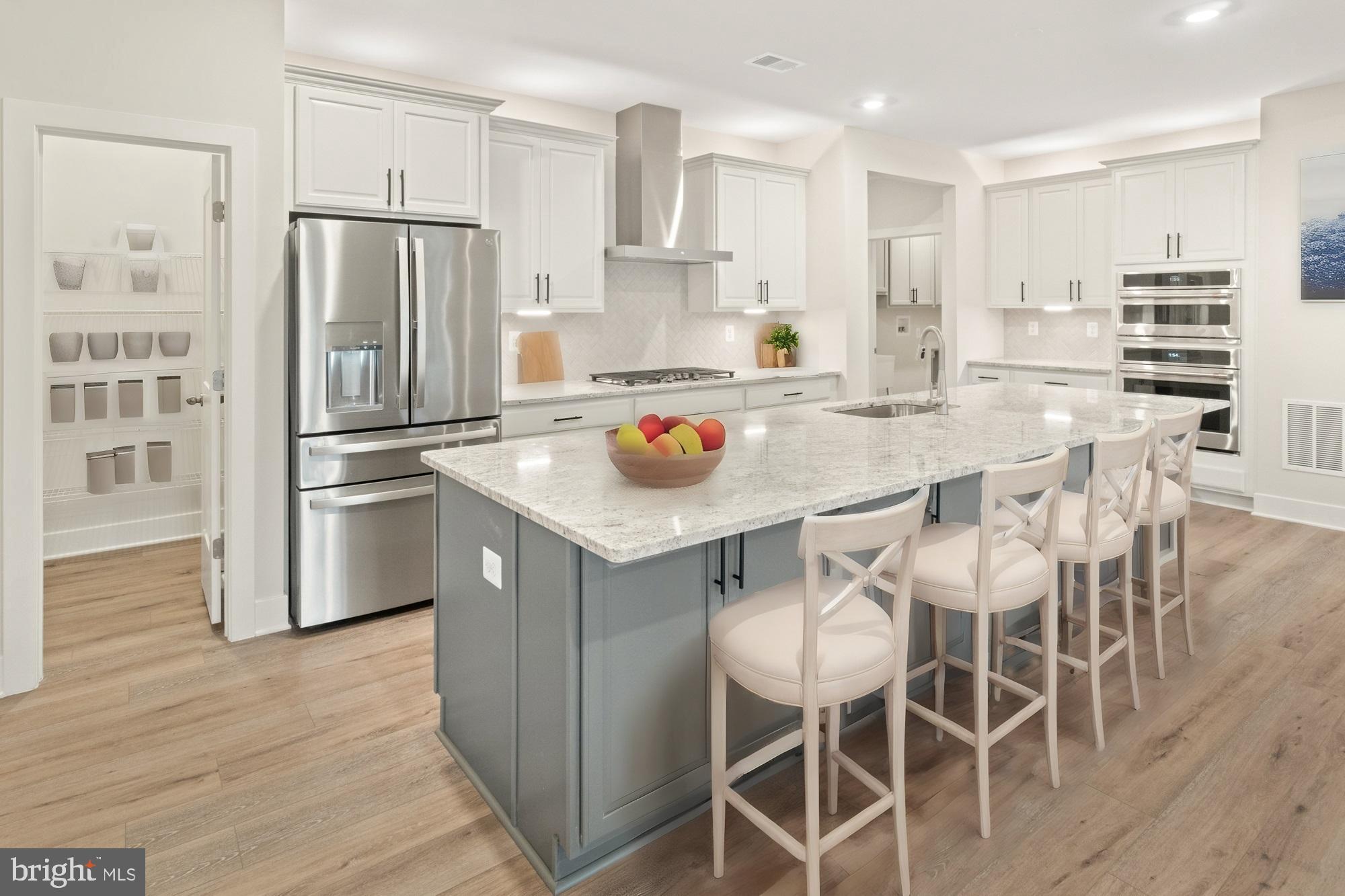 11310 Ingels Court Issue, MD 20645 - Photo 4 of 11 a kitchen with stainless steel appliances and wooden cabinets
