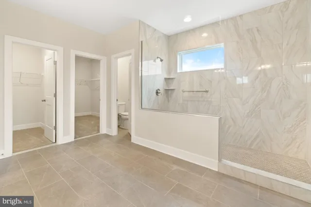a spacious bathroom with a vanity and a mirror