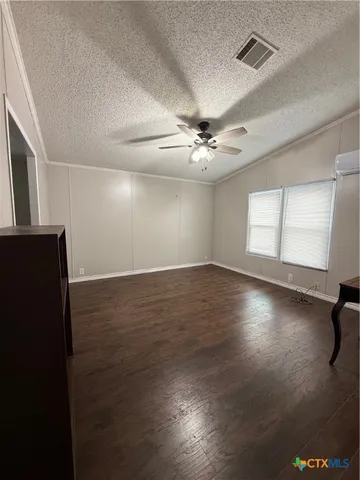 a view of wooden floor and windows in a room
