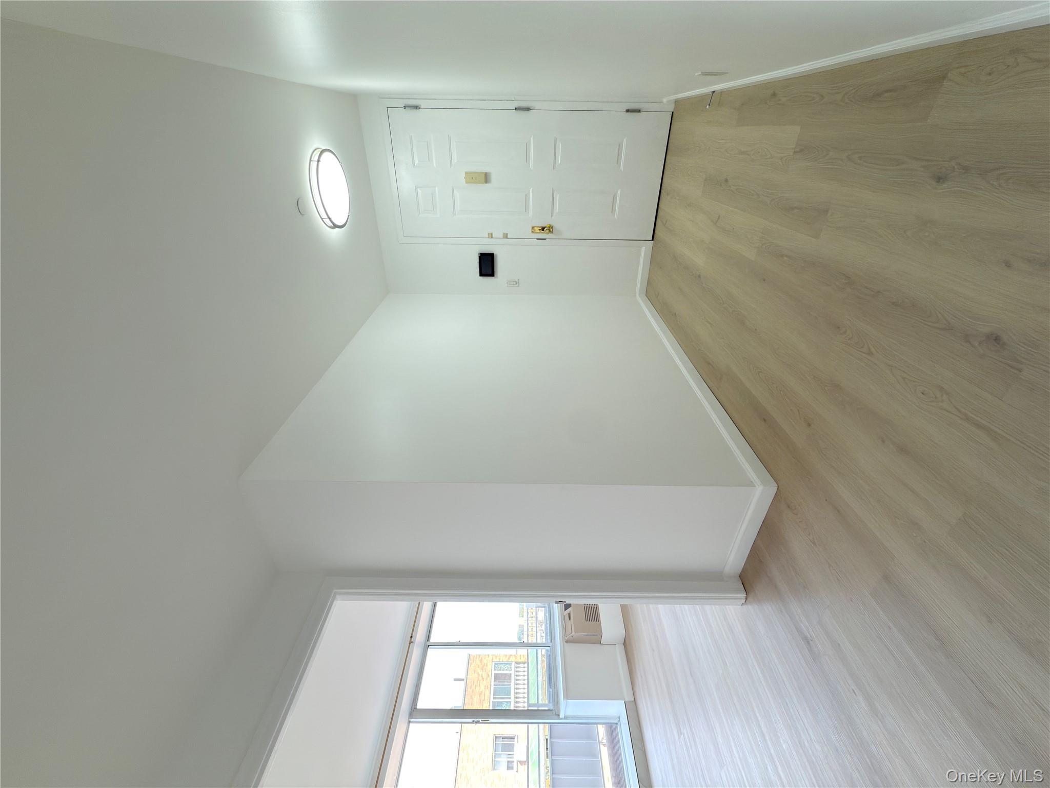 43-17 Union Street, Unit 8B Queens, NY 11355 - Photo 13 of 16 Corridor with light wood finished floors and baseboards