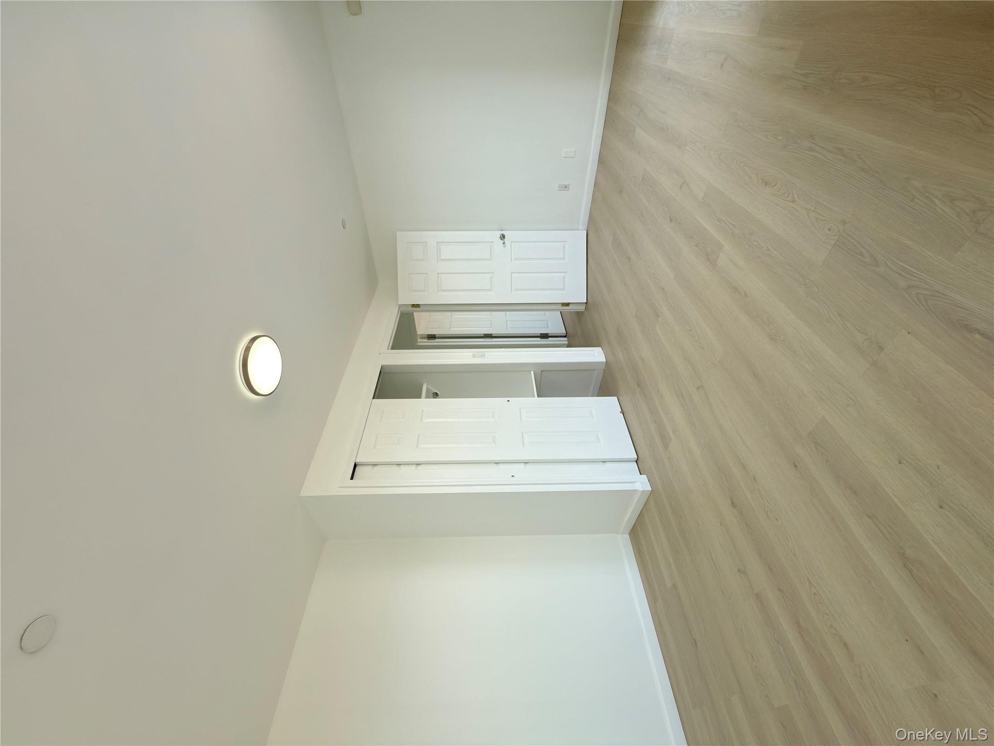 43-17 Union Street, Unit 8B Queens, NY 11355 - Photo 6 of 16 Unfurnished bedroom featuring light wood finished floors and a closet