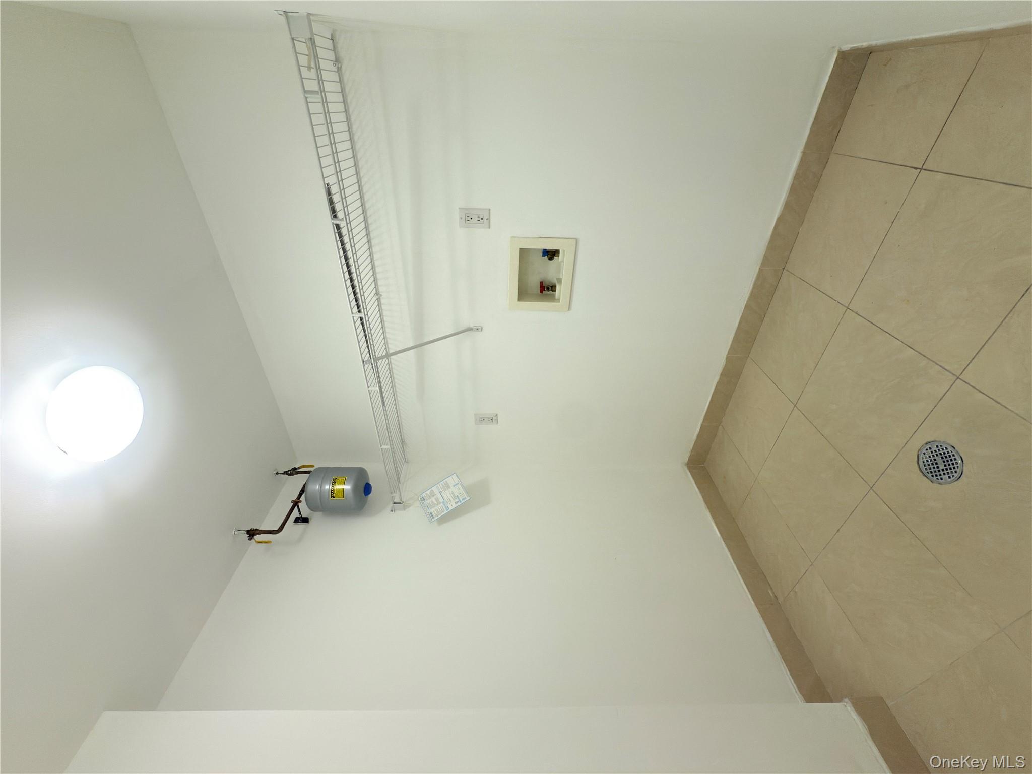 43-17 Union Street, Unit 8B Queens, NY 11355 - Photo 10 of 16 Washroom featuring light tile patterned floors and washer hookup