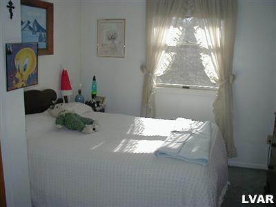 3396 Blue Ridge Road Saylorsburg, PA 18353 - Photo 2 of 11 a bedroom with a bed window and flowerpot