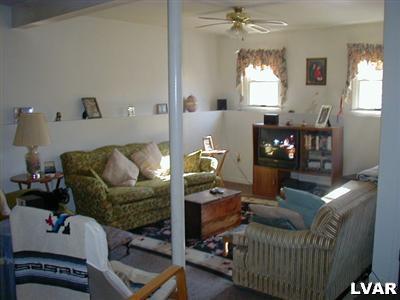 3396 Blue Ridge Road Saylorsburg, PA 18353 - Photo 5 of 11 a living room with furniture and a chandelier