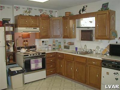 3396 Blue Ridge Road Saylorsburg, PA 18353 - Photo 7 of 11 a kitchen with stainless steel appliances granite countertop a stove a sink and a microwave