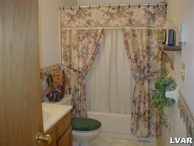 3396 Blue Ridge Road Saylorsburg, PA 18353 - Photo 9 of 11 a bathroom with a toilet and a shower curtain