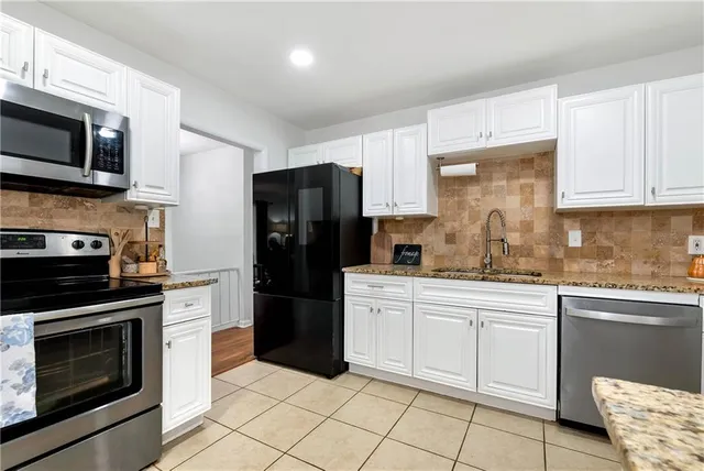 a kitchen with a refrigerator and a sink