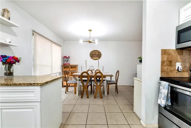 a view of a dining room with furniture and a chandelier